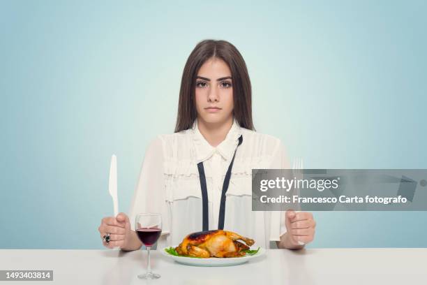 woman sitting at the table eats a roast chicken and drinks a glass of red wine - covered food with wine stock pictures, royalty-free photos & images