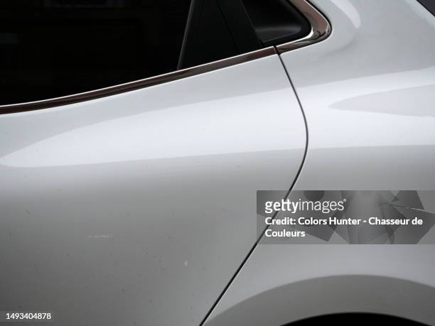 close-up of the rear door with dark, opaque window of a white car in paris, france - white color car stock pictures, royalty-free photos & images