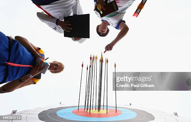 Kaori Kawanaka of Japan, Pia Lionetti of Italy and Tetyana Dorokhova of Ukraine retrieve their arrows during the Archery Ranking Round on Olympics...