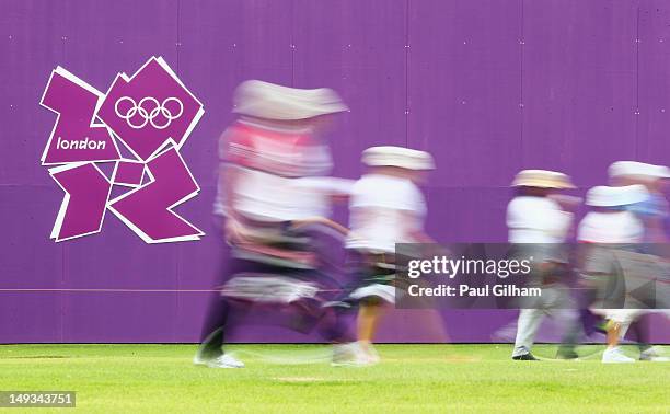 Competitors walk to retrieve their arrows during the Archery Ranking Round on Olympics Opening Day as part of the London 2012 Olympic Games at the...