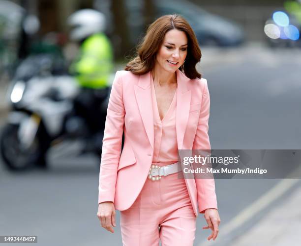 Catherine, Princess of Wales arrives, flanked by a Metropolitan Police motorcycle outrider of the Special Escort Group , for a visit to the Foundling...