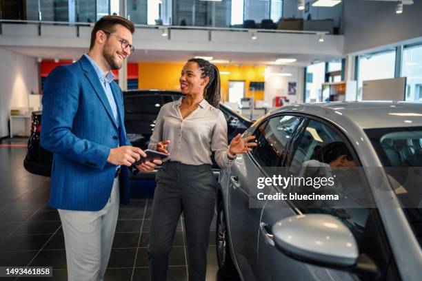 salesman helping the male customer to choose a new car - lease agreement stock pictures, royalty-free photos & images