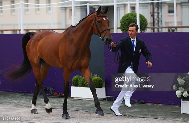Nicolas Touzaint of France leads Hildago de L'Ile during an Equestrian Eventing Horse Inspection session ahead of the London 2012 Olympic Games at...