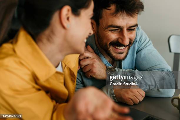 happy husband and wife read good news online on a laptop, smiling man holding documents receiving a positive decision from bank. - demonstration against the marriage for all bill stock pictures, royalty-free photos & images