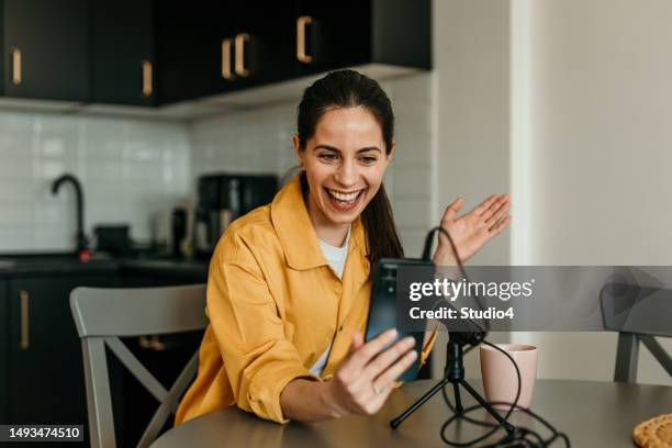 beautiful caucasian woman in yellow shirt recording her video tutorial at home. - vlogging stock pictures, royalty-free photos & images