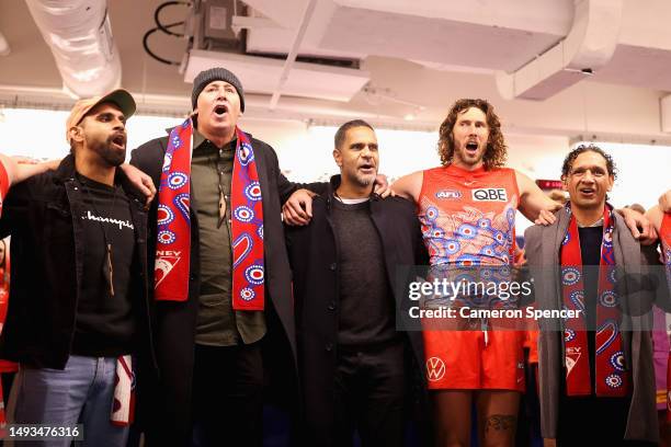 Former Swans player Michael O'Loughlin and Swans players sing the team song after winning the round 11 AFL match between Sydney Swans and Carlton...