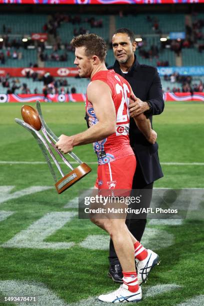 Luke Parker of the Swans accepts the Marn Grook trophy from Michael O'Loughlin after the round 11 AFL match between Sydney Swans and Carlton Blues at...