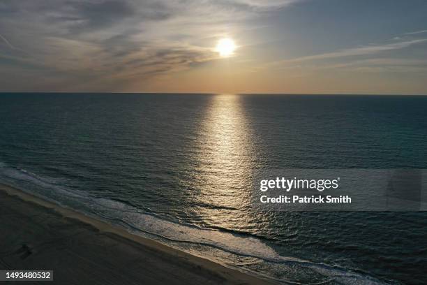 In an aerial view, the sunrises over the Atlantic Ocean on May 26, 2023 in Ocean City, Maryland. Memorial Day Weekend marks the start of beach season...