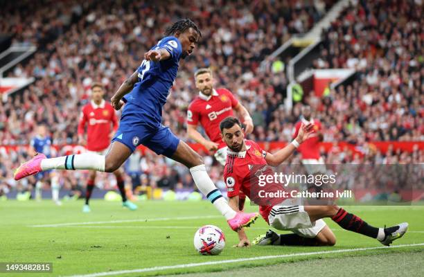 Carney Chukwuemeka of Chelsea is tackled by Bruno Fernandes of Manchester United during the Premier League match between Manchester United and...