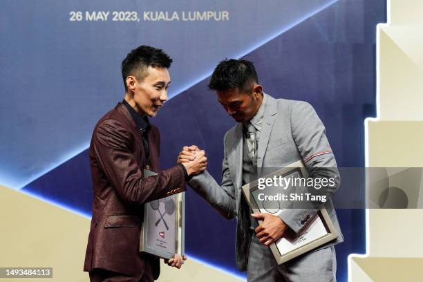 Lee Chongwei of Malaysia and Lin Dan of China shake hands after being inducted into the BWF Hall of Fame during the BWF Hall of Fame for 2023 at...