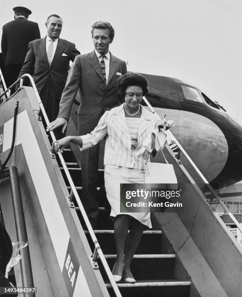 Princess Margaret and Lord Snowdon descend the steps of their plane after returning from holiday, London Airport, September 6th, 1964.