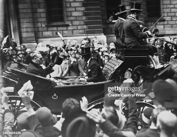 King George V with his wife, Queen Mary of Teck and Prince Edward, the Prince of Wales ride in a Landau carriage for a Thanksgiving Service at...