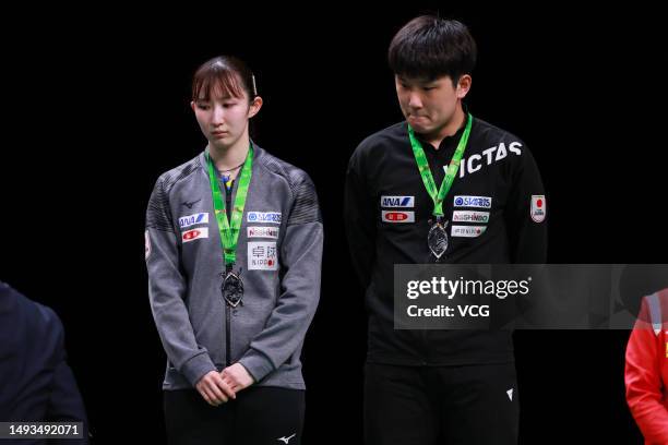 Japan's Hina Hayata and Tomokazu Harimoto stand on the podium after placing second following the Mixed Doubles table tennis final match against...