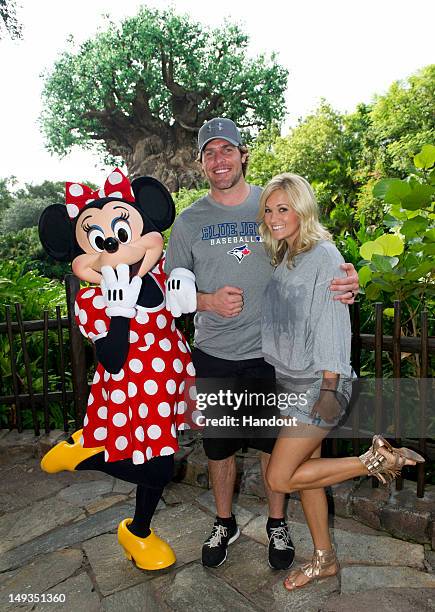 Five-time Grammy Award-winning singer Carrie Underwood and her husband, NHL Nashville Predators star Mike Fisher, pose with Minnie Mouse at Disney's...