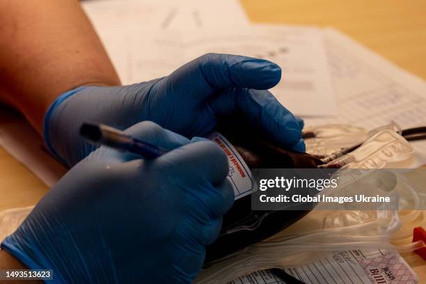 Nurse fills out blood bag information in mobile blood station on May 25, 2023 in Lviv, Ukraine. FESTrepublic space with Lviv Regional Blood Service...