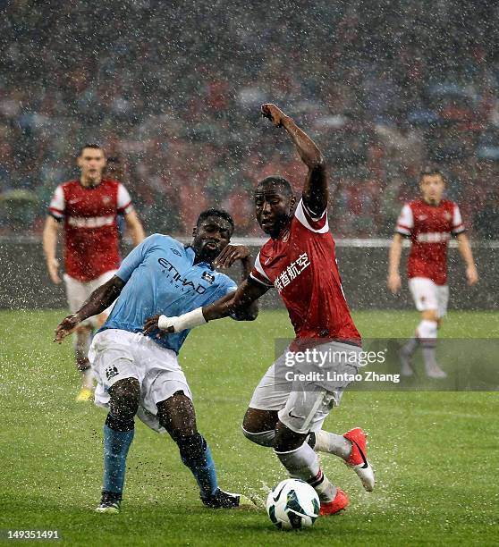 Benik Afobe of Arsenal FC challenges Kolo Toure of Manchester City during the pre-season Asian Tour friendly match between Arsenal and Manchester...