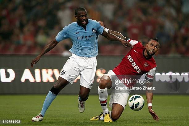 Kyle Bartley of Arsenal FC challenges Yaya Toure of Manchester City during the pre-season Asian Tour friendly match between Arsenal and Manchester...