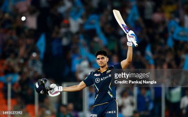 Shubman Gill of Gujarat Titans raises his bat to the crowd as he celebrates after scoring a century during the IPL Qualifier match between Gujarat...
