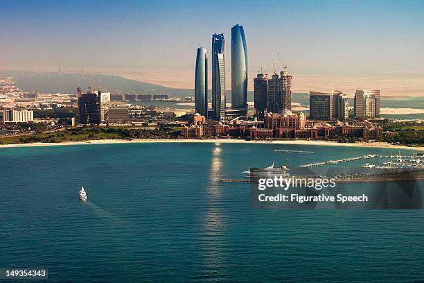 etihad towers and emirates palace - abu dhabi stockfoto's en -beelden