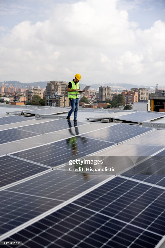 Engineer reading the levels of power supply of solar panels
