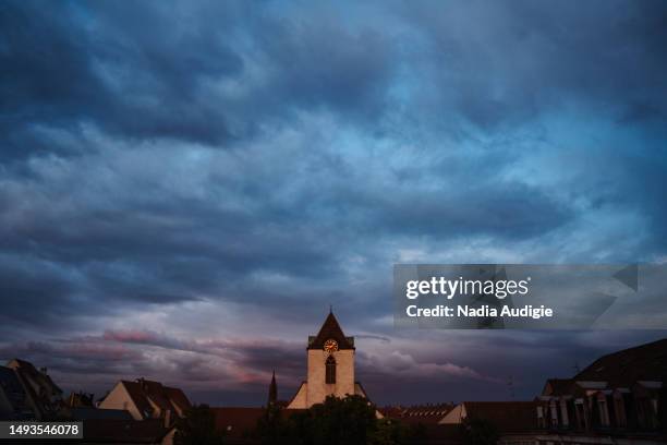 strasbourg cityscape with a clock tower and notre dame cathedral - christian audigie stock pictures, royalty-free photos & images