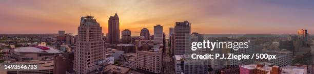 aerial view of buildings in city against sky during sunset,cleveland,ohio,united states,usa - cleveland sunset stock pictures, royalty-free photos & images