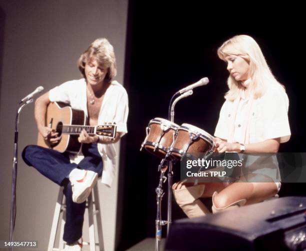 English/Australian singer and songwriter Andy Gibb and Swedish singer and songwriter Agnetha Fältskog, of the supergroup ABBA, perform on stage...