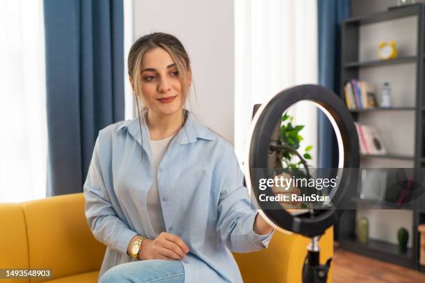 smiling young woman female influencer doing a vlog post at home - one woman only videos stock pictures, royalty-free photos & images