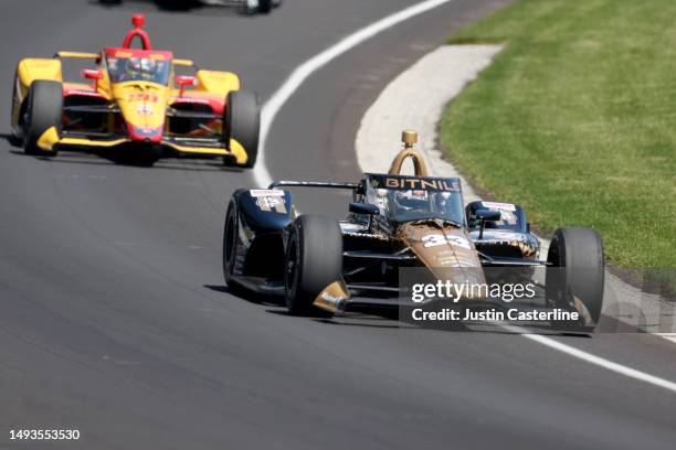 Ed Carpenter, driver of the Bitnile Chevrolet, leads Roman Grosjean, driver of the DHL Honda, during practice at Carb Day for the 107th Indianapolis...