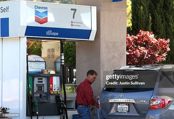 Customer pumps gas into his car at a Chevron gas station on July 27, 2012 in San Rafael, California. Chevron reported a 6.8 percent decline in second...