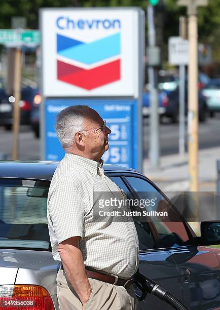 Customer pumps gas into his car at a Chevron gas station on July 27, 2012 in San Rafael, California. Chevron reported a 6.8 percent decline in second...