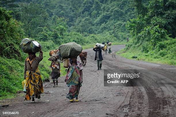 Civilians flee heavy gunfire on the road leading from Rugari to Kibumba in the east of the Democratic Republic of Congo on July 27, 2012. Gunfire...