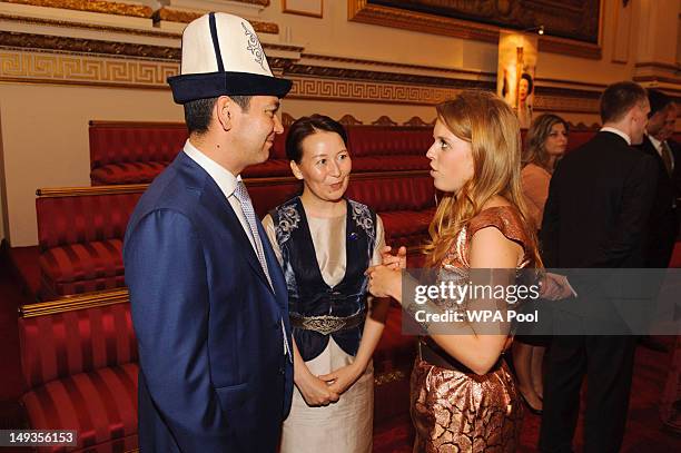 Princess Beatrice speaks to the Prime Minister of Kyrgyzstan Omurbek Babanov and Rita Birbaeva during a reception at Buckingham Palace a reception...
