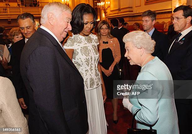 Queen Elizabeth II meets US First Lady Michelle Obama and US Ambassador Louis Susman at a reception at Buckingham Palace in London to welcome heads...