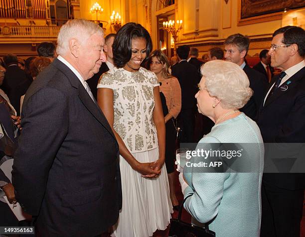 Queen Elizabeth II talks with US First Lady Michelle Obama and US Ambassador Louis Susman at a reception at Buckingham Palace in London to welcome...