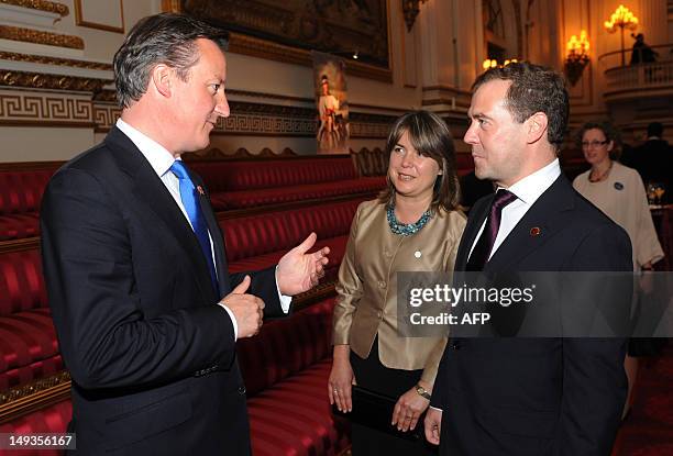 British Prime Minister David Cameron chats with Russian Prime Minister Dmitry Medvedev during a reception at Buckingham Palace to welcome heads of...