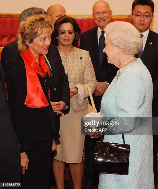 Queen Elizabeth II talks to President of Switzerland Eveline Widmer-Schlumpf during a reception at Buckingham Palace to welcome heads of state and...