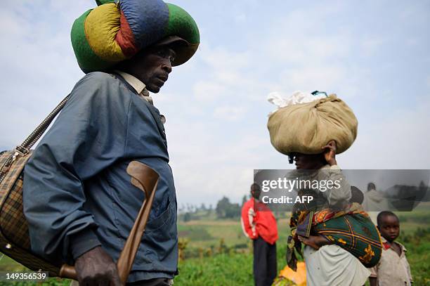 Civilians flee heavy gunfire on the road leading from Rugari to Kibumba in the east of the Democratic Republic of Congo on July 27, 2012. Gunfire...