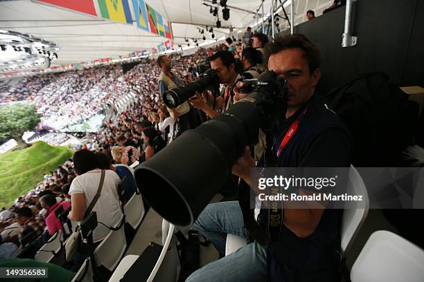 Photographers take pictures in the stadium prior to the Opening Ceremony of the London 2012 Olympic Games at the Olympic Stadium on July 27, 2012 in...