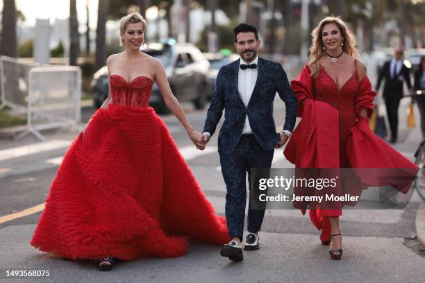 Verena Kerth seen wearing a wide red bandeau dress, Cartier love bracelet and Cartier juste un clou and Marc Ternezi seen wearing a dark blue suit...