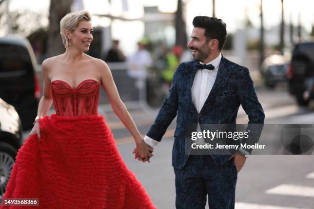 Verena Kerth seen wearing a wide red bandeau dress, Cartier love bracelet and Cartier juste un clou and Marc Ternezi seen wearing a dark blue suit...