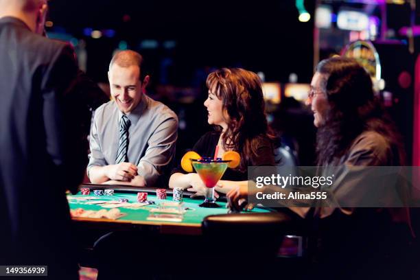 group of happy diverse people at the blackjack table - blackjack stock pictures, royalty-free photos & images