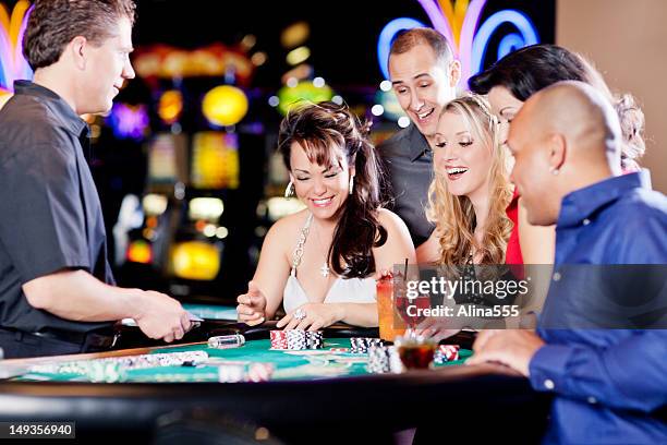 group of happy diverse people at the blackjack table - casino dealer stockfoto's en -beelden