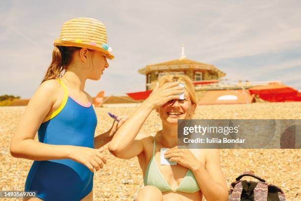 women different age playing games on a beach - spelregels stockfoto's en -beelden