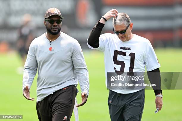 Defensive coordinator Jim Schwartz of the Cleveland Browns talks with former NFL linebacker D'Qwell Jackson during the Cleveland Browns OTAs at...