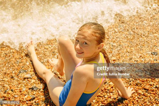 happy girl having fun on a beach - tween girls swimwear stock pictures, royalty-free photos & images