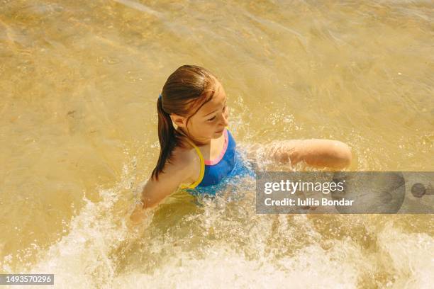 happy girl having fun on a beach - tween girls swimwear stock pictures, royalty-free photos & images