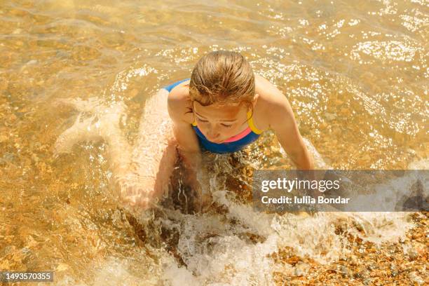 happy girl having fun on a beach - tween girls swimwear stock pictures, royalty-free photos & images