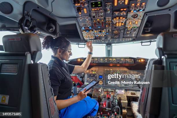 avionics technician checking cockpit in aircraft maintenance factory - cockpit stock pictures, royalty-free photos & images