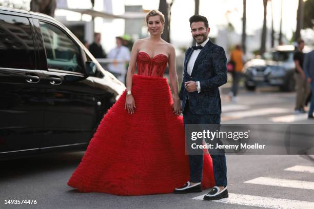 Verena Kerth seen wearing a wide red bandeau dress, Cartier love bracelet and Cartier juste un clou and Marc Ternezi seen wearing a dark blue suit...